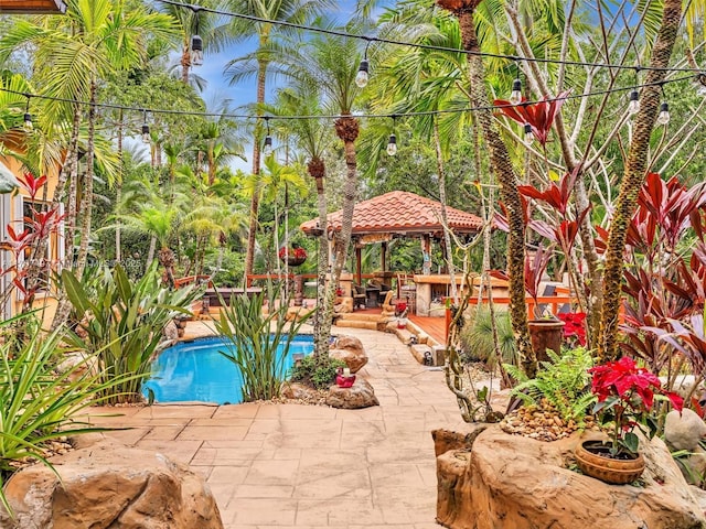 outdoor pool featuring a gazebo and a patio