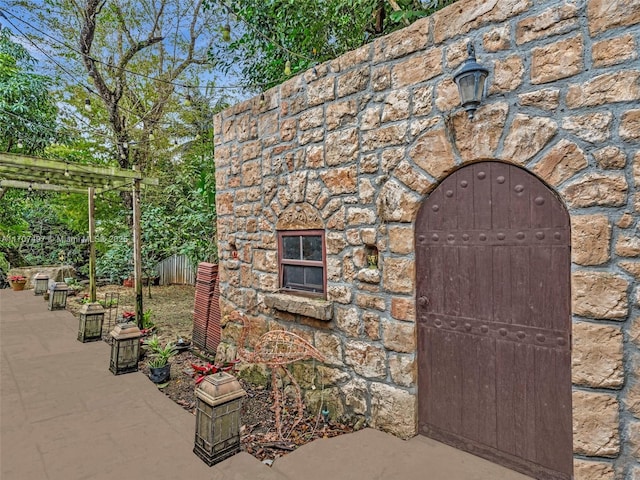 view of outbuilding featuring fence