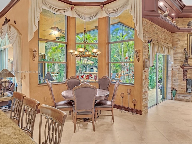 dining space featuring ornamental molding and ceiling fan with notable chandelier