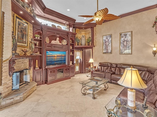 living room featuring ceiling fan, built in shelves, crown molding, and a fireplace