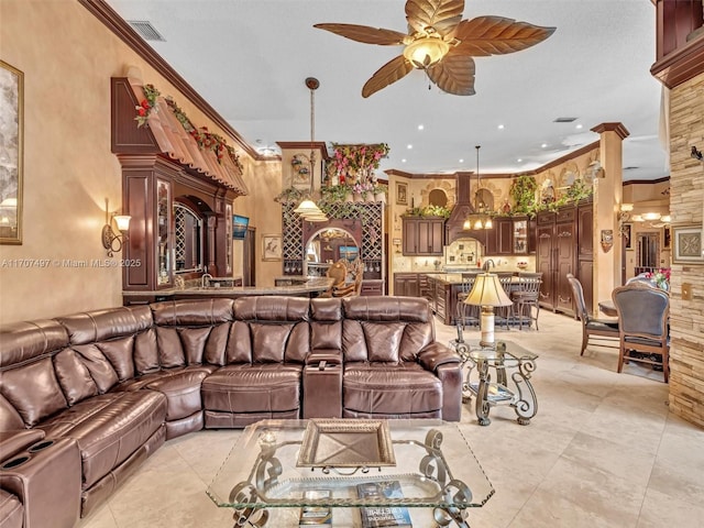 living room featuring ceiling fan with notable chandelier, light tile patterned floors, and ornamental molding