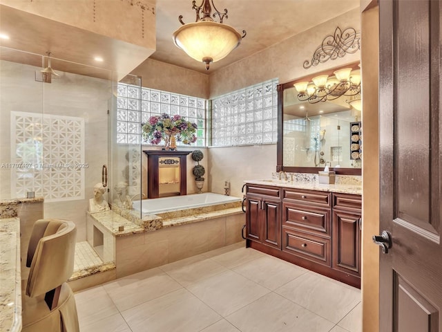 bathroom with vanity, tile patterned flooring, tile walls, and independent shower and bath