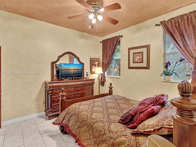 bedroom featuring ceiling fan and light tile patterned floors