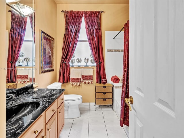 full bathroom featuring toilet, tile patterned floors, vanity, and shower / tub combo with curtain