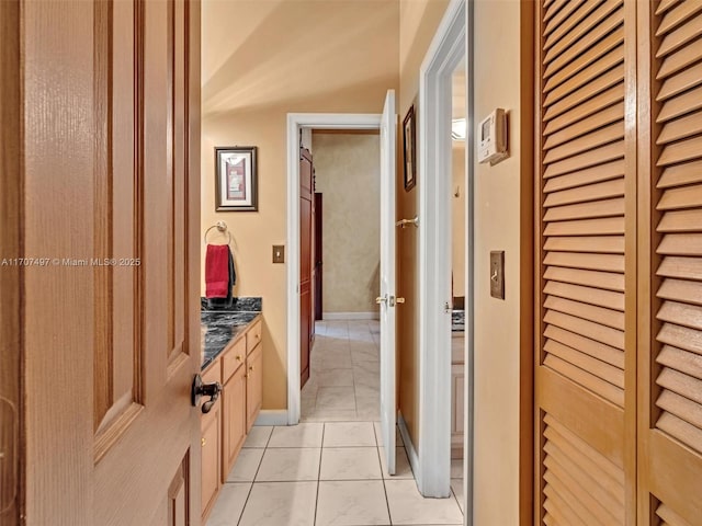 bathroom featuring baseboards, vanity, and tile patterned floors