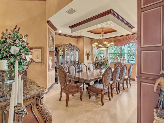 dining space with light tile patterned flooring, visible vents, a chandelier, and ornamental molding