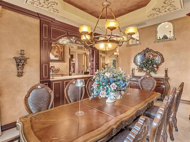 dining area featuring crown molding and a raised ceiling