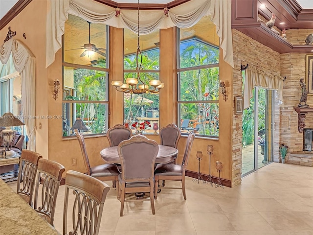 dining area featuring ceiling fan with notable chandelier and crown molding