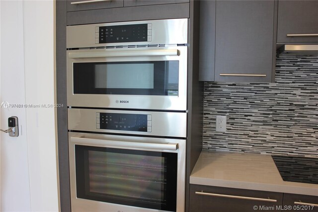 kitchen featuring backsplash and double oven