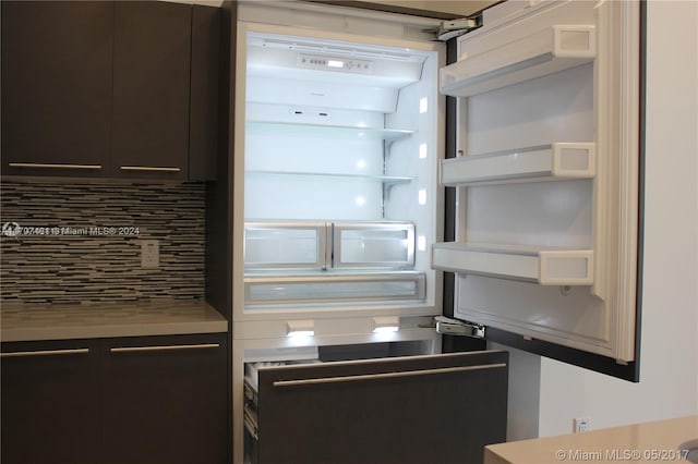 kitchen with tasteful backsplash and built in refrigerator