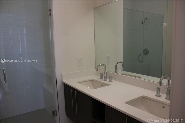 bathroom with vanity and a shower with door