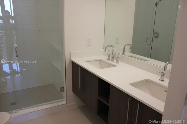 bathroom featuring toilet, vanity, and walk in shower