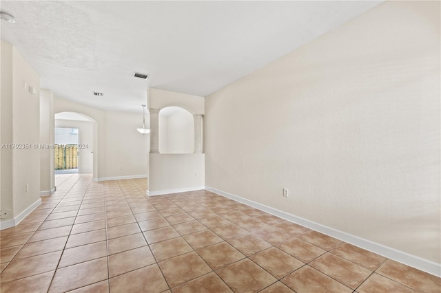 spare room featuring light tile patterned flooring