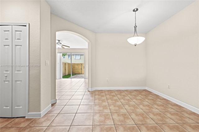 unfurnished room with ceiling fan and light tile patterned floors