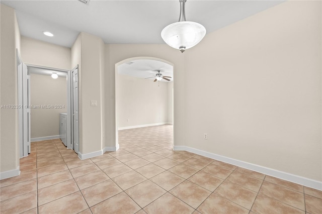 empty room featuring ceiling fan and light tile patterned flooring