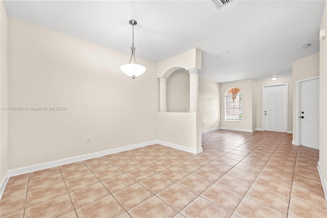 tiled spare room with ornate columns