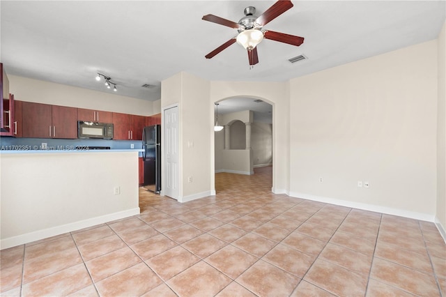 2557 SE 14th St, Homestead, FL 33035 - kitchen with black appliances, arched walkways, a ceiling fan, light tile patterned floors, and light countertops