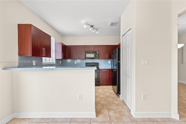 kitchen with kitchen peninsula, light tile patterned flooring, and black appliances