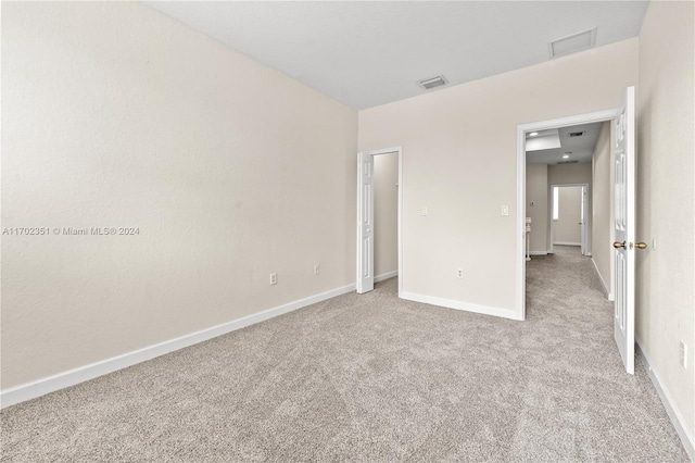 unfurnished bedroom featuring light colored carpet