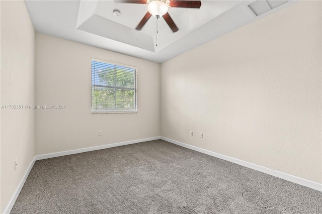 2557 SE 14th St, Homestead, FL 33035 - empty room featuring carpet floors, a raised ceiling, ceiling fan, and a smoke detector