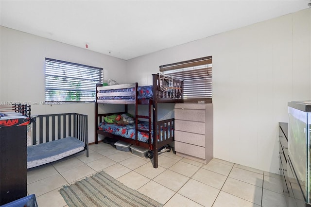 bedroom with light tile patterned floors