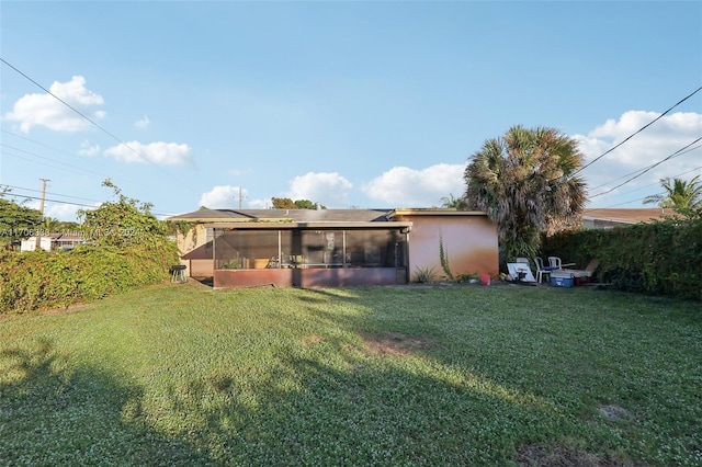 back of house featuring a lawn