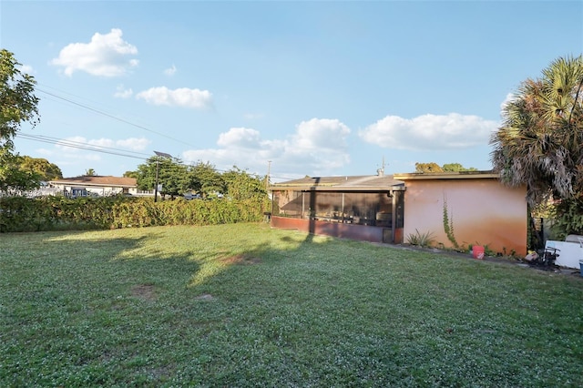 view of yard with a sunroom