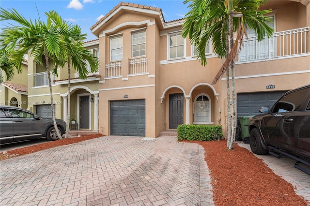 view of property featuring a balcony and a garage