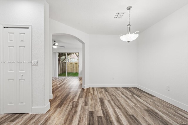 1476 SE 26th Ave, Homestead, FL 33035 - spare room featuring wood finished floors, arched walkways, and a ceiling fan