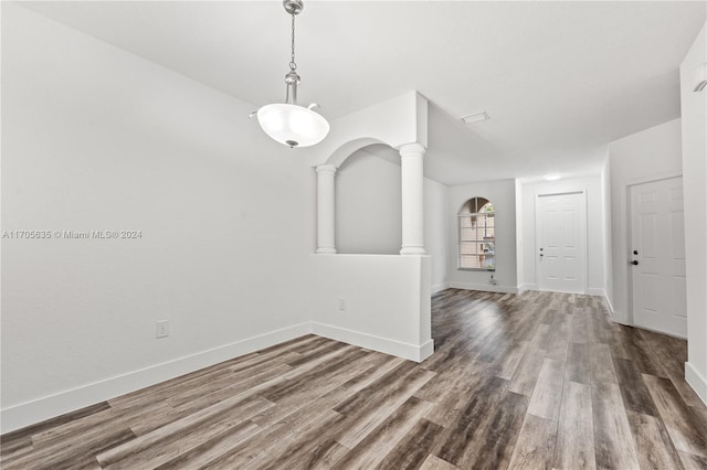 1476 SE 26th Ave, Homestead, FL 33035 - empty room with wood finished floors, arched walkways, and ornate columns