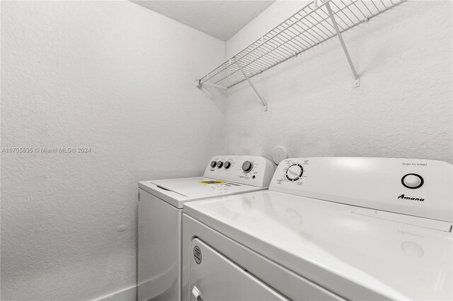 1476 SE 26th Ave, Homestead, FL 33035 - laundry room with separate washer and dryer and a textured wall