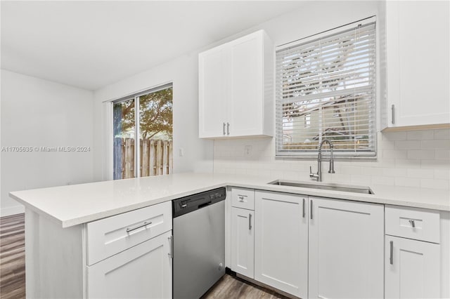 kitchen featuring white cabinetry, dishwasher, sink, dark hardwood / wood-style flooring, and kitchen peninsula