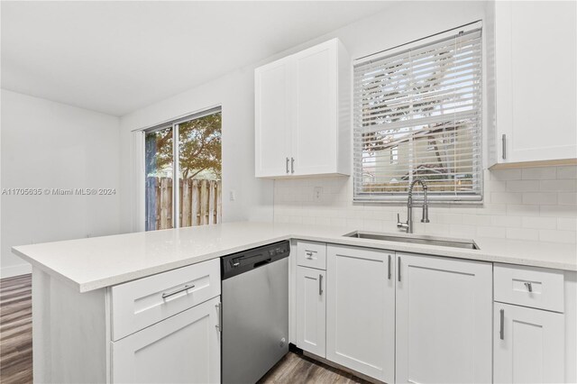 1476 SE 26th Ave, Homestead, FL 33035 - kitchen featuring stainless steel dishwasher, a peninsula, dark wood-style flooring, and white cabinets