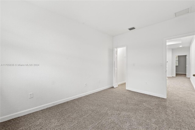 1476 SE 26th Ave, Homestead, FL 33035 - carpeted empty room with baseboards