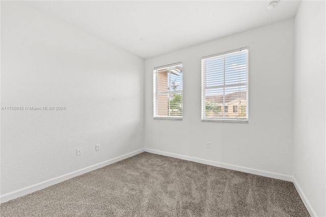 1476 SE 26th Ave, Homestead, FL 33035 - carpeted empty room featuring a smoke detector and vaulted ceiling