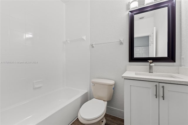 full bathroom featuring hardwood / wood-style floors, vanity, toilet, and tiled shower / bath