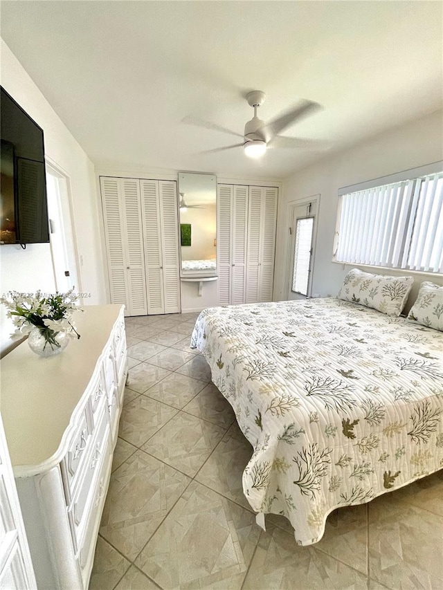 bedroom with two closets and ceiling fan