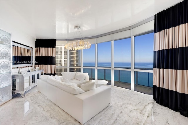 living room featuring expansive windows, a water view, and a chandelier