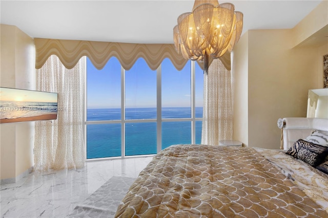 bedroom featuring multiple windows, a water view, and an inviting chandelier