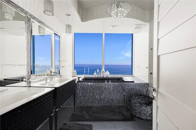 bathroom with a notable chandelier, plenty of natural light, a water view, and vanity