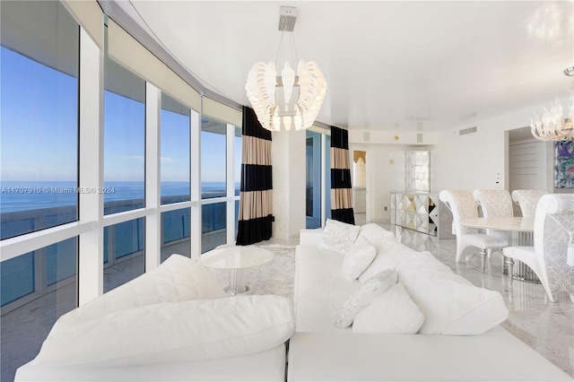 living room with a water view and a chandelier