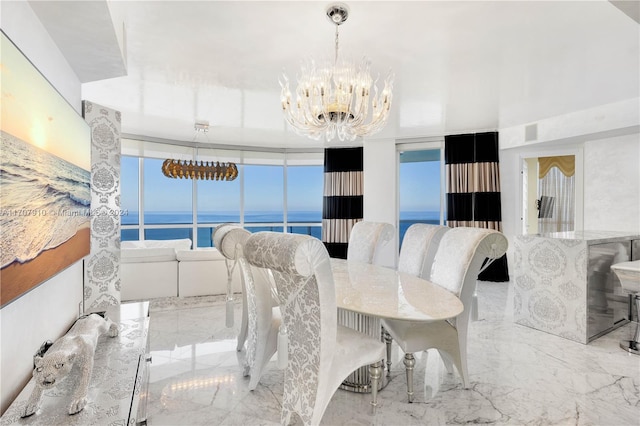 dining room featuring a chandelier, a water view, and floor to ceiling windows