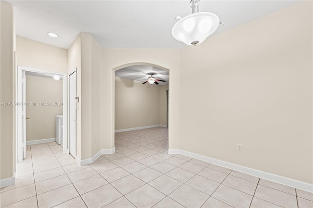 spare room featuring light tile patterned floors and ceiling fan