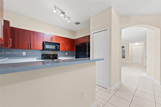 kitchen featuring black appliances, light tile patterned floors, and kitchen peninsula