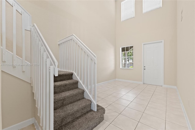 tiled entrance foyer with a high ceiling