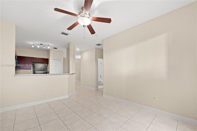 tiled empty room featuring ceiling fan