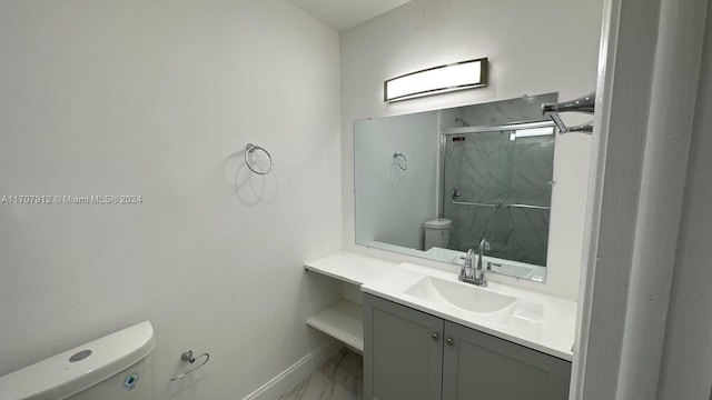 bathroom with a shower with door, vanity, and toilet