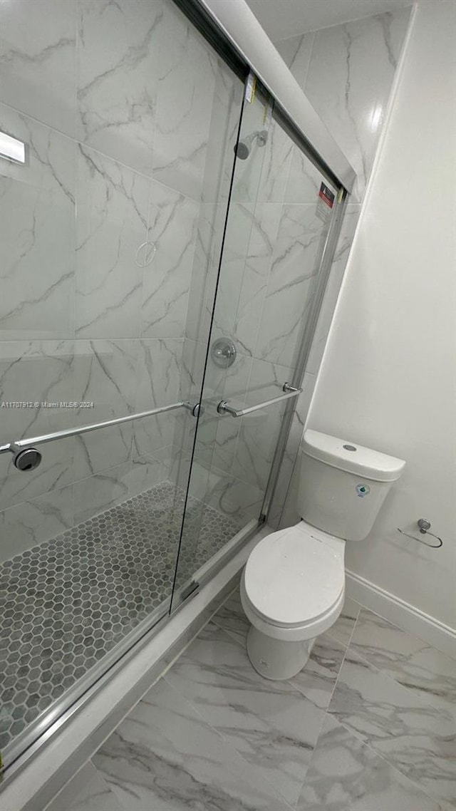 bathroom featuring toilet and walk in shower