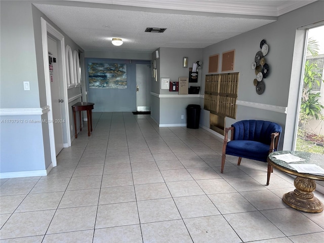 living area featuring a textured ceiling and light tile patterned flooring