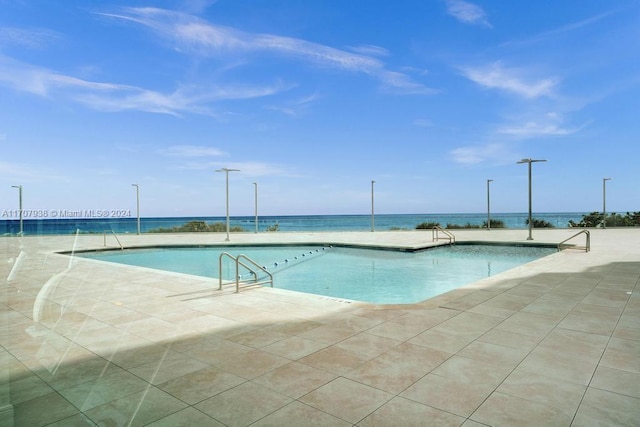 view of swimming pool with a water view